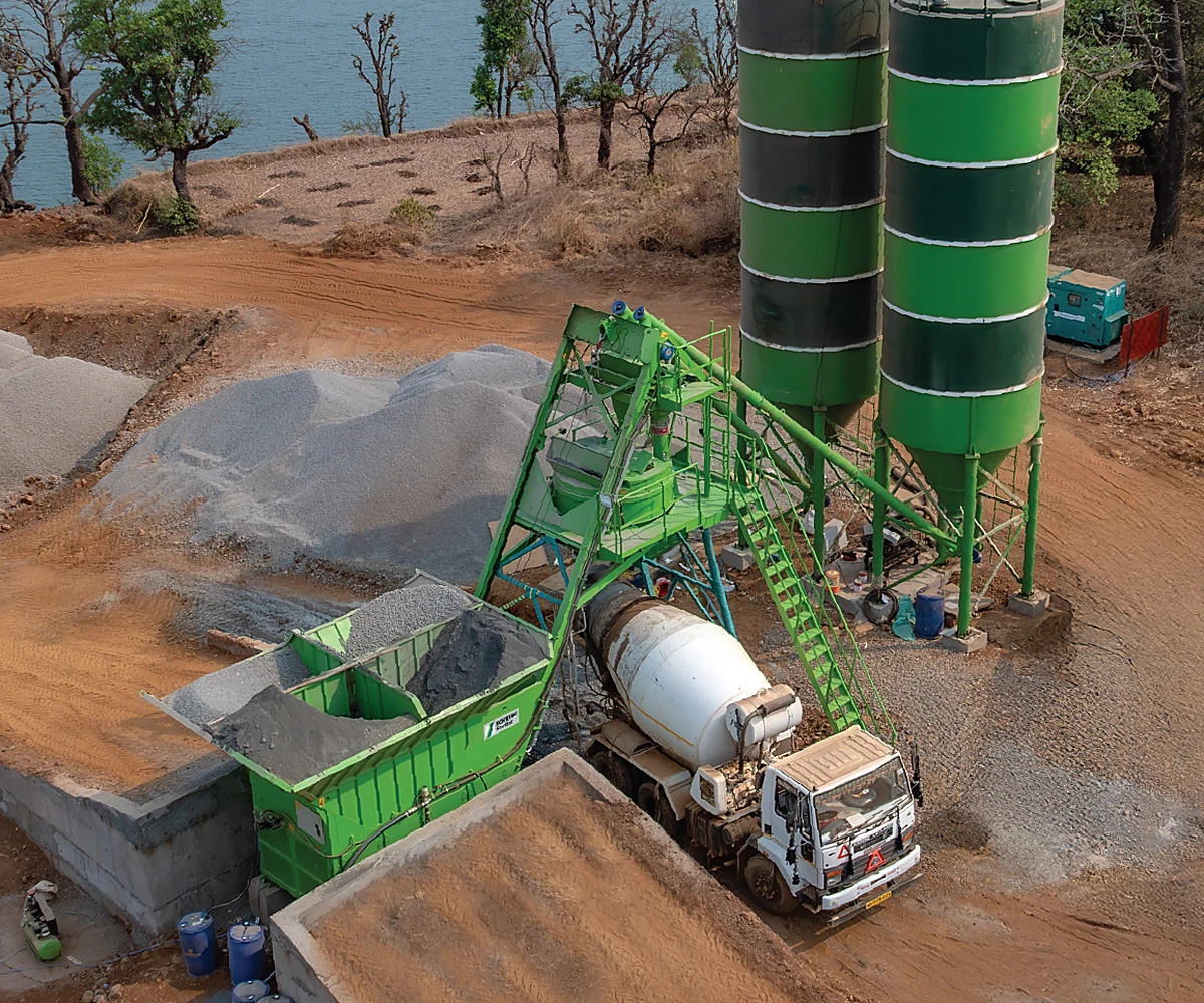 SCHWING mini batching plant producing concrete at a project site