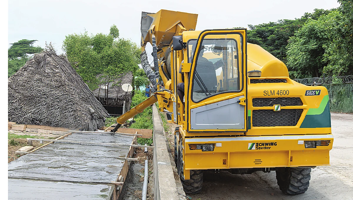 Self-loading mixer pouring concrete at a construction site